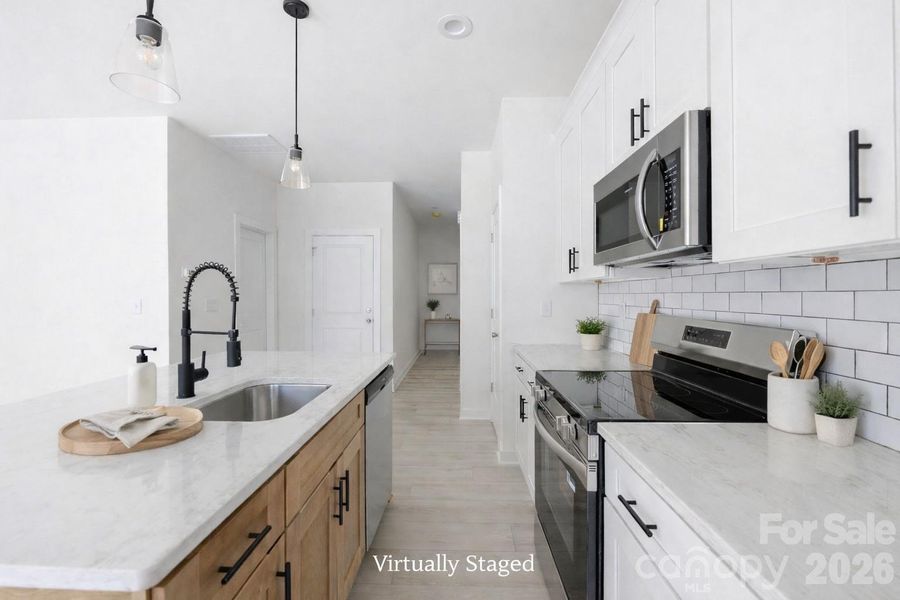Kitchen with Level 3 Quartz Countertops and Stainless Appliances! Virtually Staged Photo