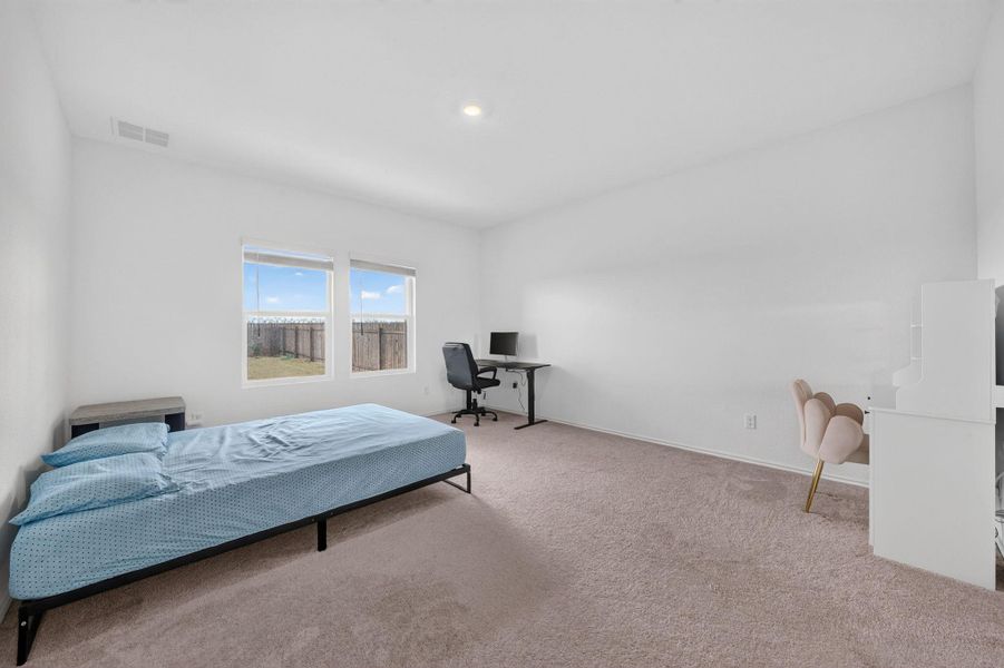 A quiet bedroom offering dual windows with outdoor views and soft carpeting for comfort. A quiet bedroom offering dual windows with outdoor views and soft carpeting for comfort.