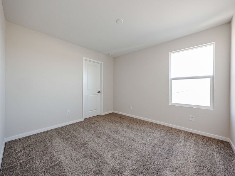 A room with a door and a carpet.