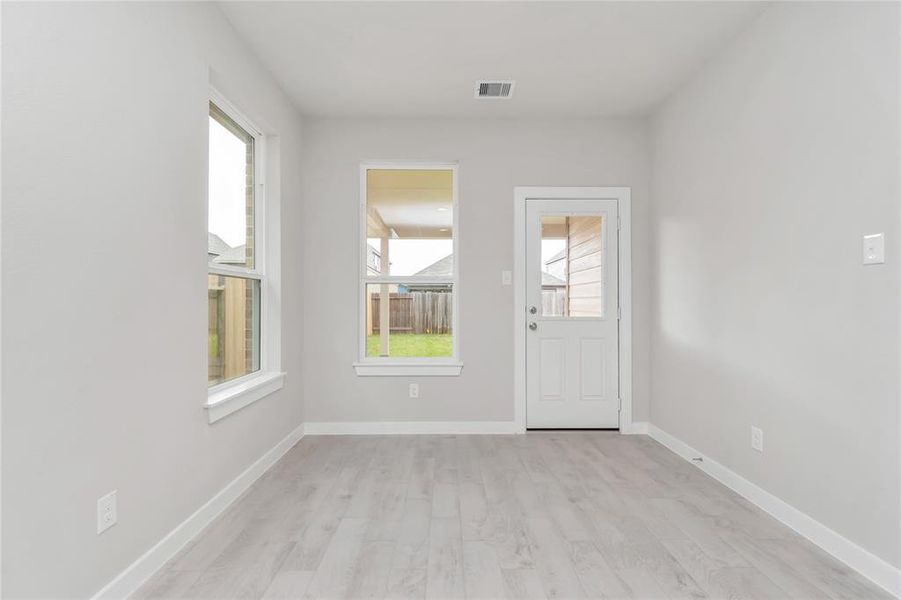 From breakfast area, step through the back door for a breath of fresh air onto the covered patio, extending your living space to the outdoors. Sample photo of completed home with similar floor plan. As-built interior colors and selections may vary