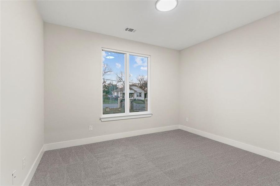 Spare room featuring carpet flooring and baseboards Spare room featuring carpet flooring and baseboards