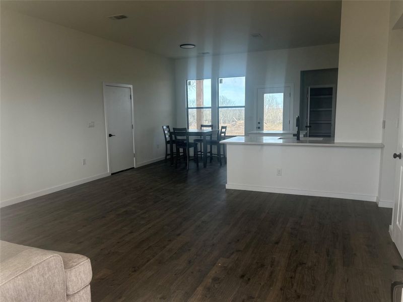 Living area with dark wood-type flooring and baseboards Living area with dark wood-type flooring and baseboards