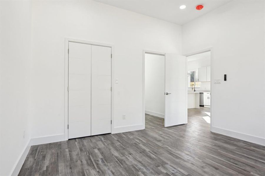 Unfurnished bedroom with recessed lighting, baseboards, and wood finished floors