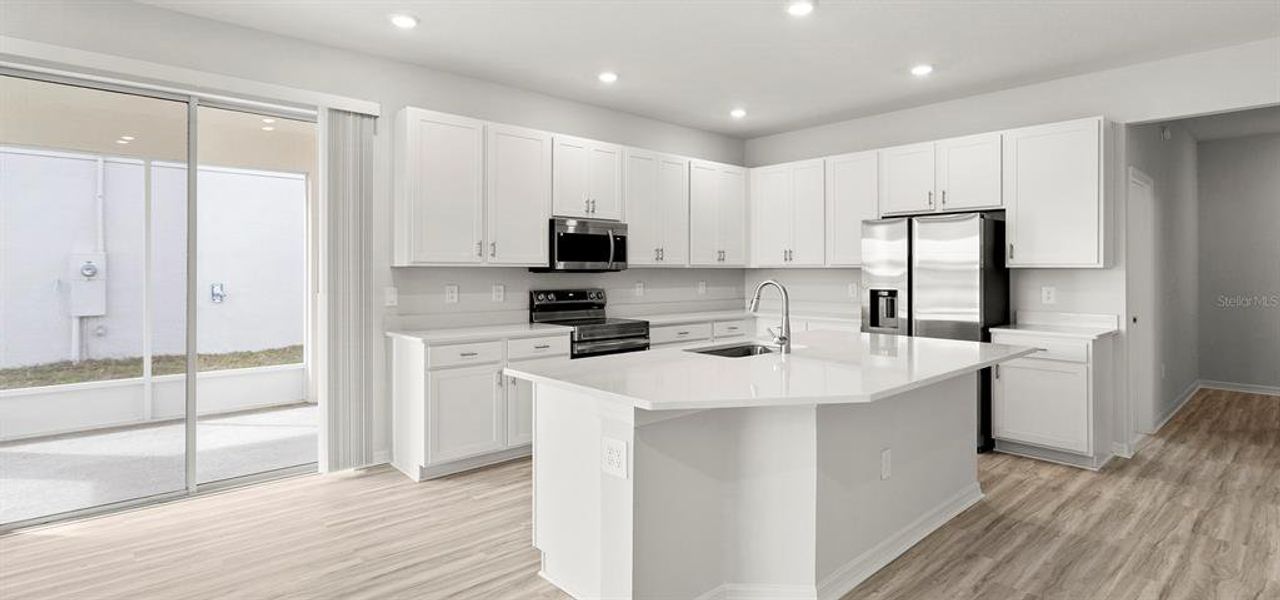 Furnished interior view inside a new home in Estates at Hickory Cove - Bungalows, St. Cloud (Image 13).