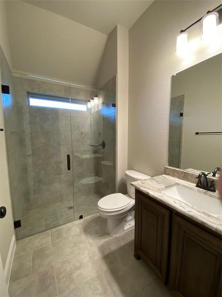 Bath 2 downstairs offers 12x24 tile, walk-in shower, framless glass, granite vanity, and window for natural light.