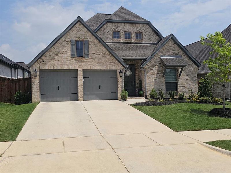 Front exterior of a new home in M3 Ranch, Mansfield, TX, highlighting curb appeal (Image 1). Front exterior of a new home in M3 Ranch, Mansfield, TX, highlighting curb appeal (Image 1).