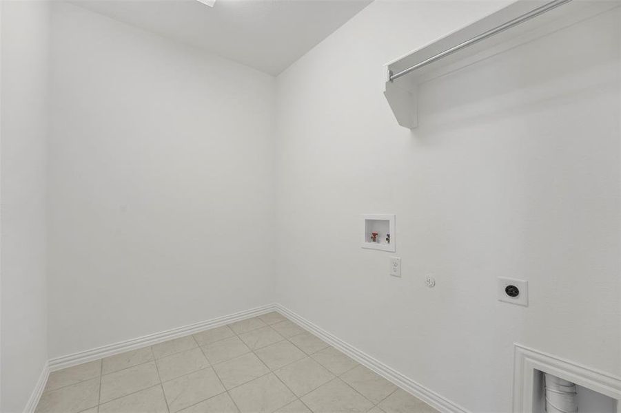 Laundry room featuring washer hookup, light tile patterned flooring, hookup for a gas dryer, and hookup for an electric dryer