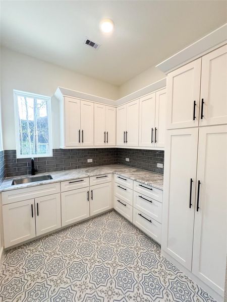 Custom Utility Includes Sink, Abundant Storage, and Counter Space