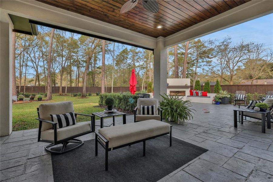 If you thought the house was amazing, wait until you step outside in the back yard! Look up at the tongue and grove wooden ceilings. Look down at the stamped concrete flooring. Look out to the fireplace!