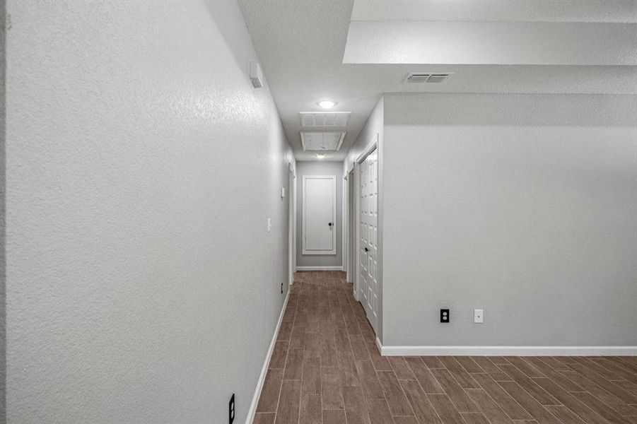 Hall featuring baseboards and wood finished floors Hall featuring baseboards and wood finished floors