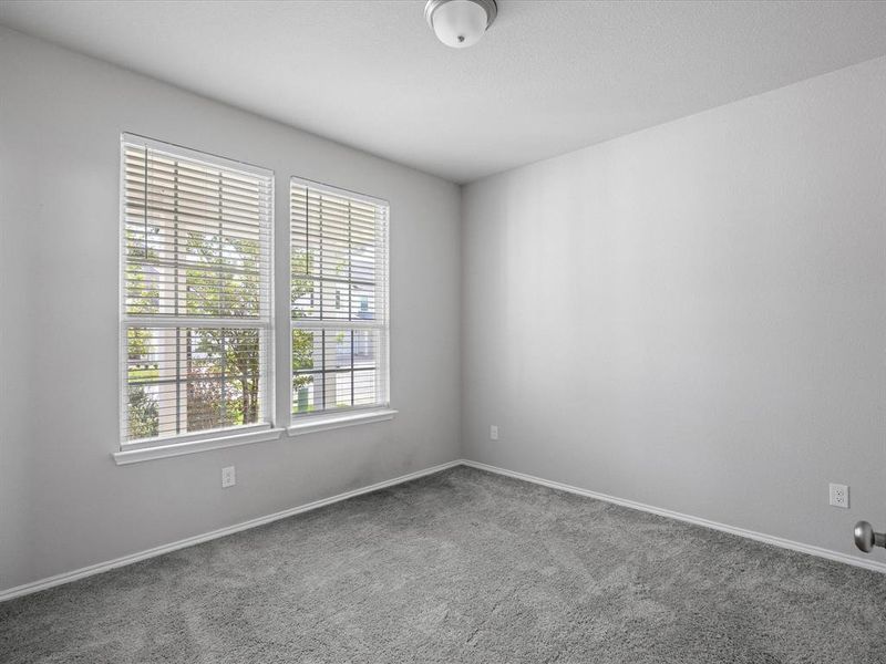 Carpeted spare room with baseboards Carpeted spare room with baseboards