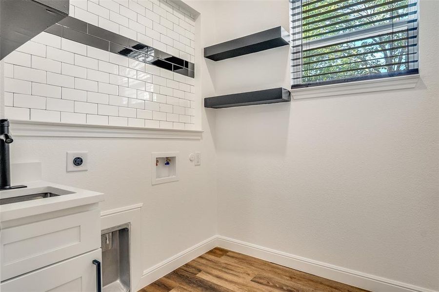 Washroom featuring light wood-style floors, electric dryer hookup, and hookup for a washing machine