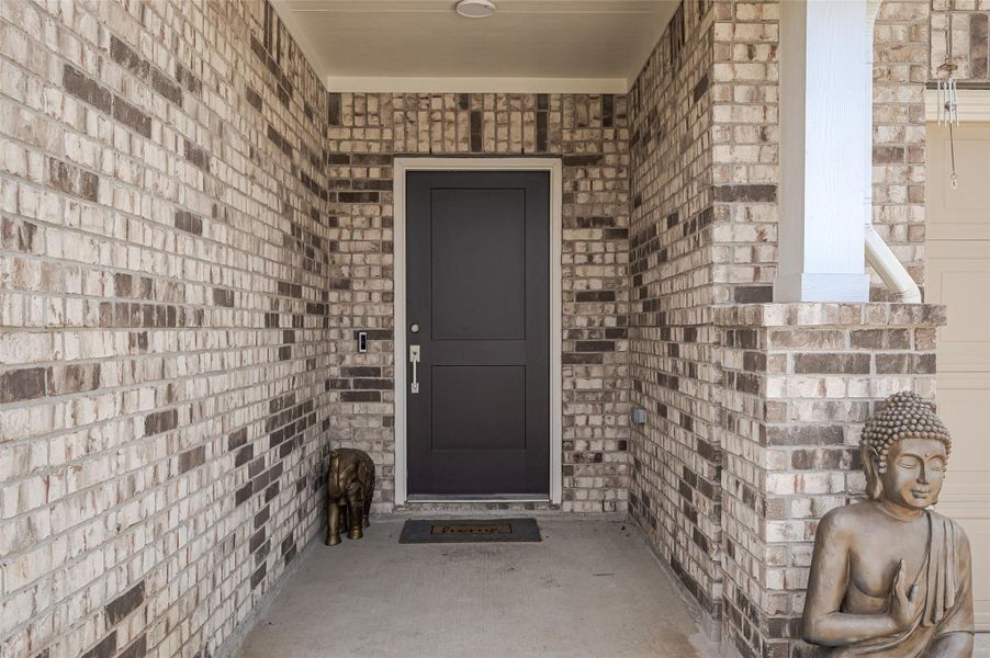 Covered stone entryway at front door.