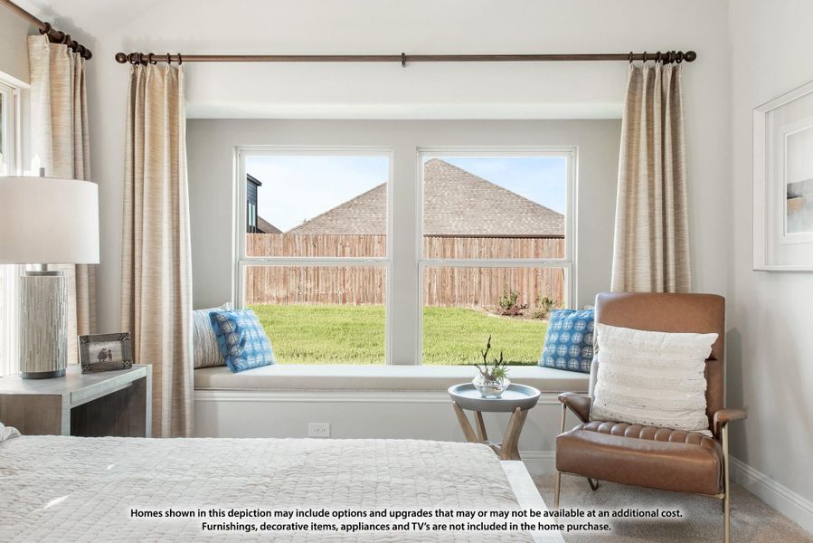Bedroom with built-in window seat, large double windows, linen curtains, and a leather accent chair with backyard view.