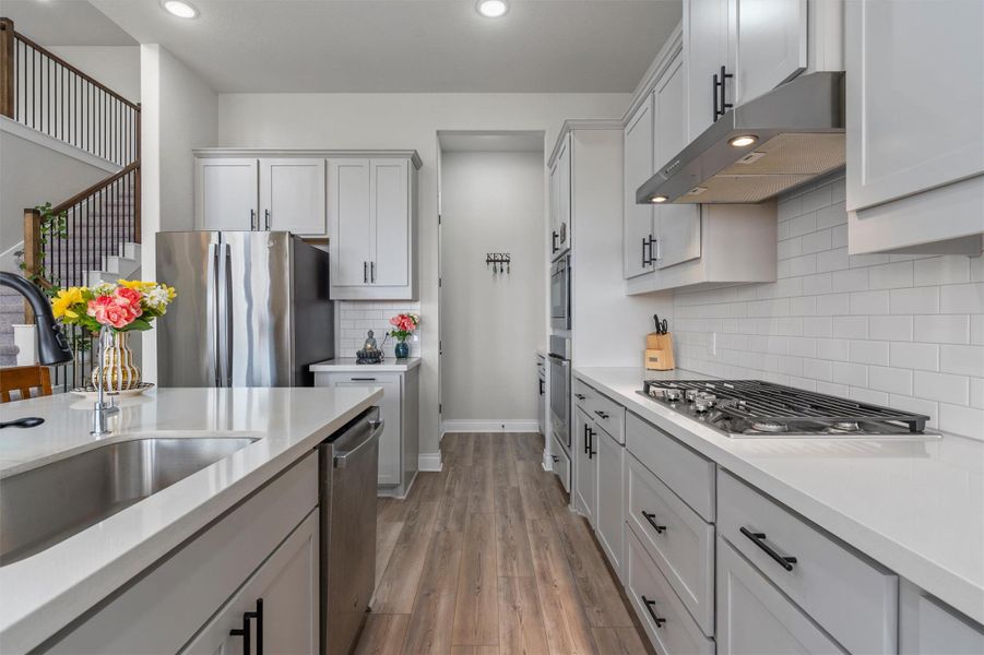 Streamlined cabinetry and premium stone counters define this modern workspace.
