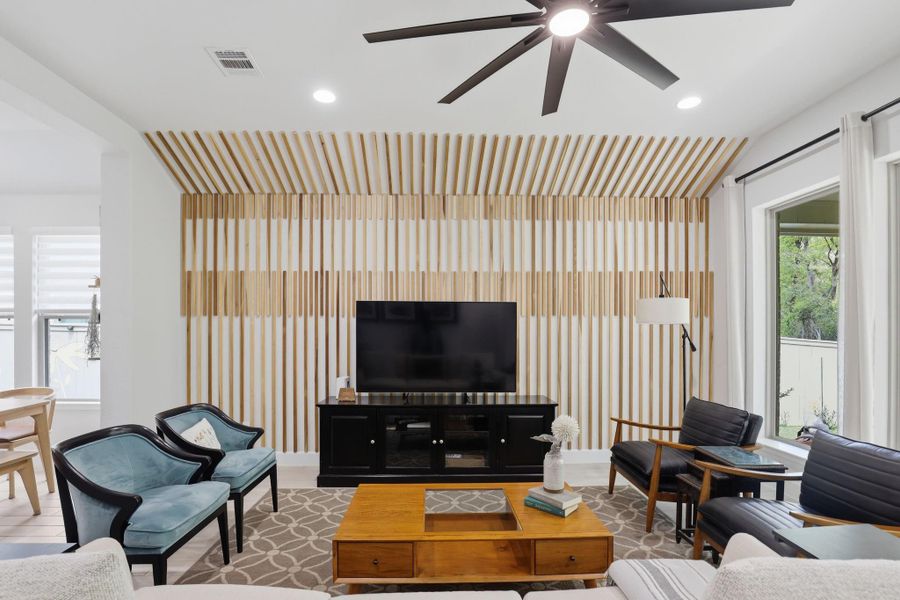 The floor-to-ceiling custom woodwork serves as a striking, one-of-a-kind backdrop for the main living area.