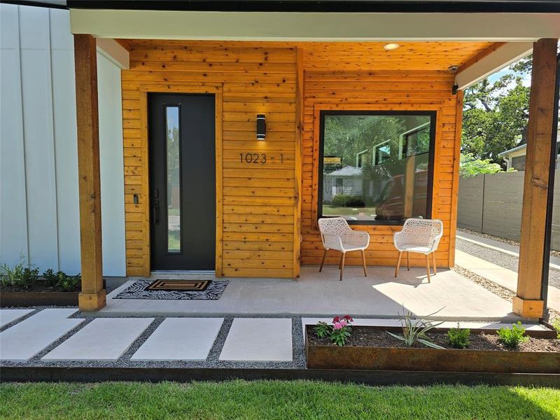 Lots of space to sit and relax on the front porch next to the custom metal planter boxes - drip irrigation in them for easy watering with your Rachio smart controller.