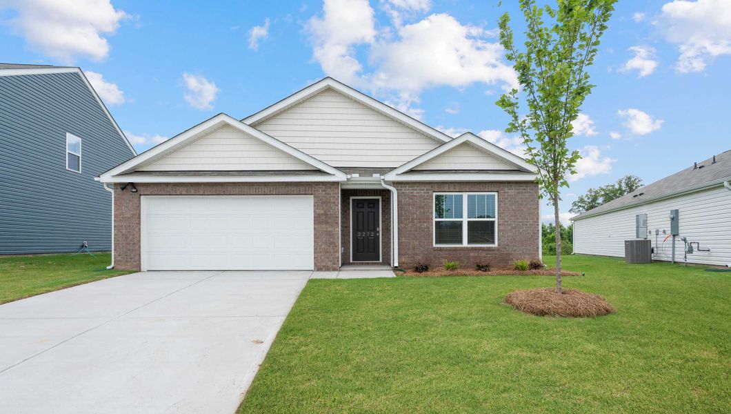 Front exterior of a new home in Treemont Commons, Wellford, SC, highlighting curb appeal (Image 1).