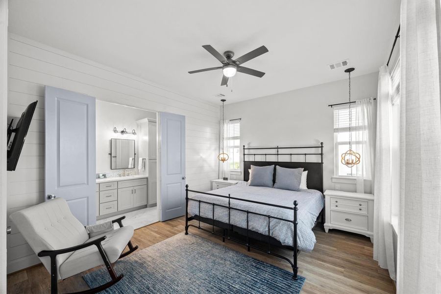 The primary bedroom exudes serenity with its shiplap wall accents, creating a calming and coastal-inspired retreat.