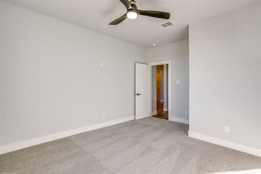 Unfurnished room featuring carpet floors and a ceiling fan