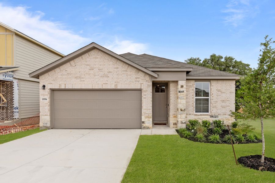 Front exterior of a new home in Hunter's Ranch, San Antonio, TX, highlighting curb appeal (Image 1).