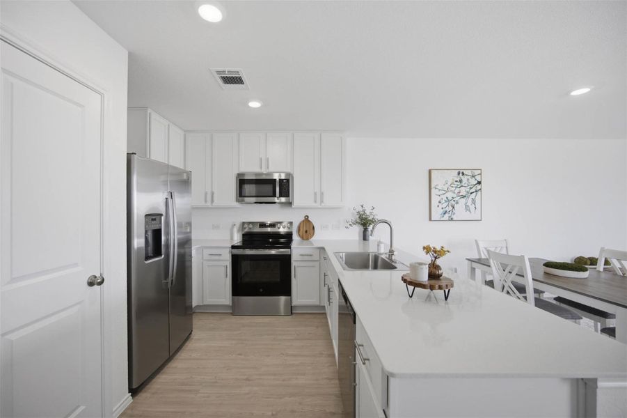 Smooth countertops and contemporary cabinetry define this modern culinary workspace.