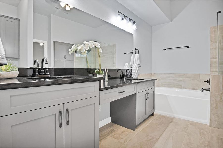 Bathroom with tile patterned floors, and soaking garden tub.