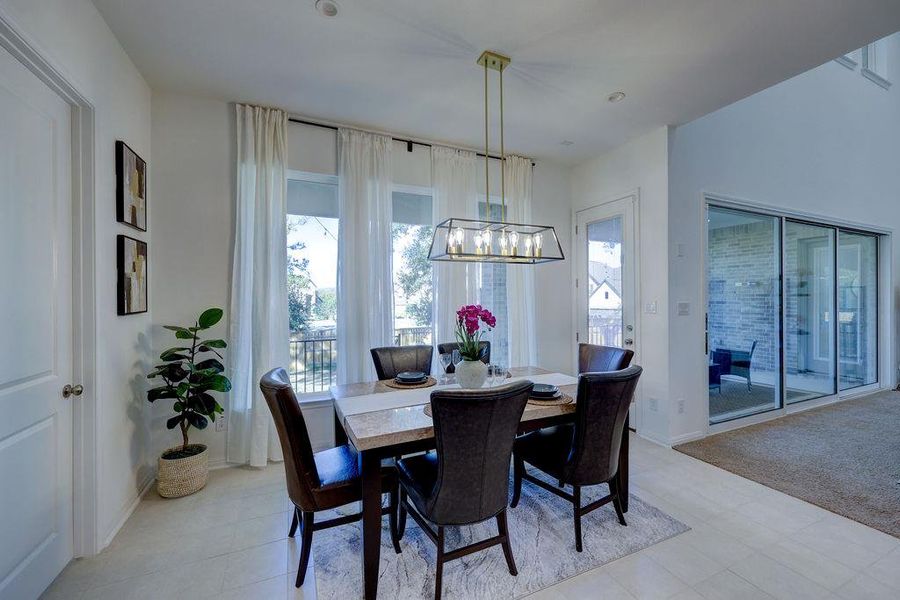 Dining area with a chandelier and light carpet
