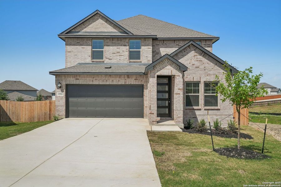 Front exterior of a new home in Arcadia Ridge - Premier Series, San Antonio, TX, highlighting curb appeal (Image 23). Front exterior of a new home in Arcadia Ridge - Premier Series, San Antonio, TX, highlighting curb appeal (Image 23).