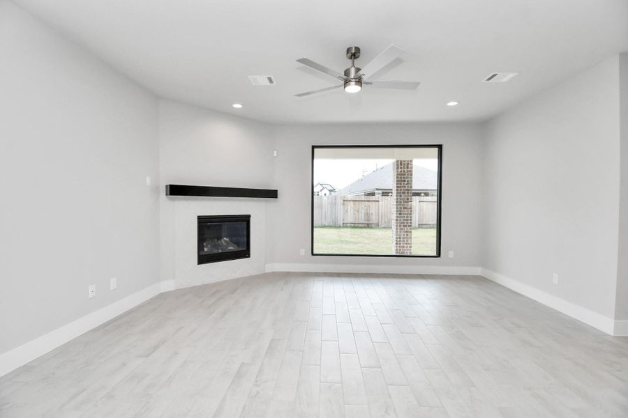 Family room flooded with natural light through the expansive window. The premium tile flooring adds a touch of luxury to the space, creating the perfect setting for relaxing moments and cherished gatherings with loved ones. Family room flooded with natural light through the expansive window. The premium tile flooring adds a touch of luxury to the space, creating the perfect setting for relaxing moments and cherished gatherings with loved ones.