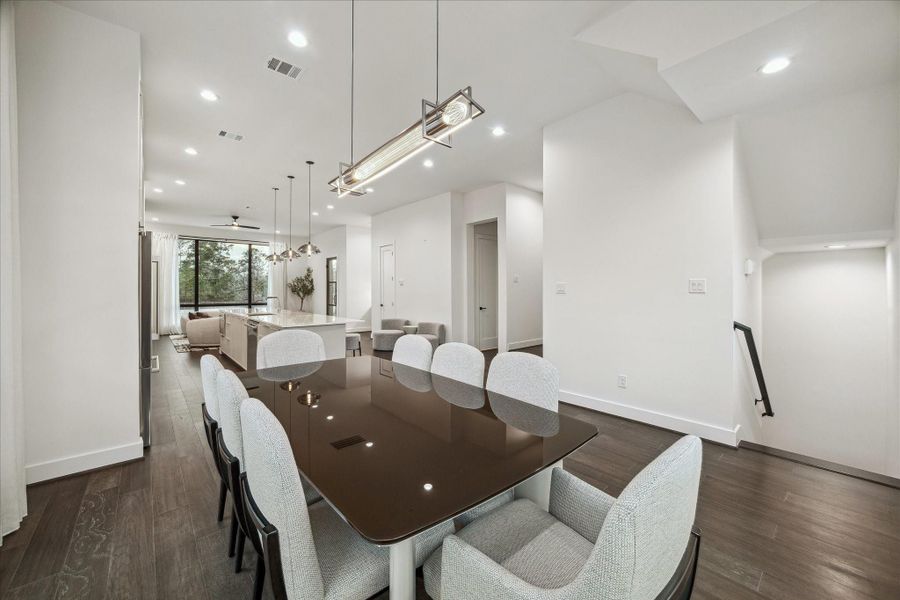 Elegant dining space positioned within the open-concept second floor, defined by generous proportions and seamless connection to the kitchen and living areas. High ceilings and recessed lighting enhance the bright, airy atmosphere. The linear layout allows for effortless flow, making it ideal for both intimate gatherings and larger celebrations.