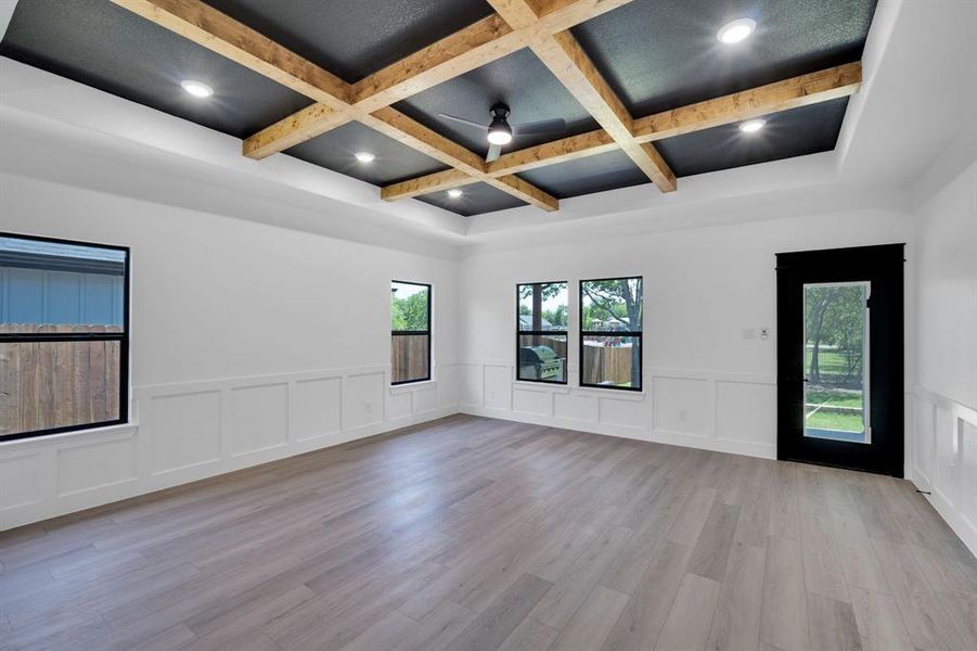 Family living room with wainscoted walls and door leading to yard.