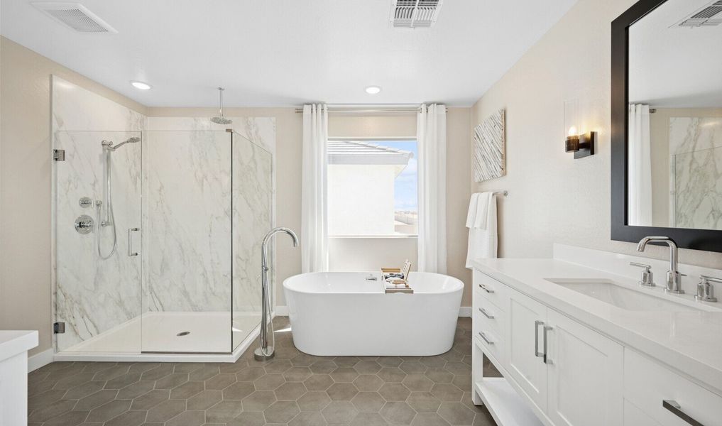 Primary bath with glass shower enclosure and freestanding tub