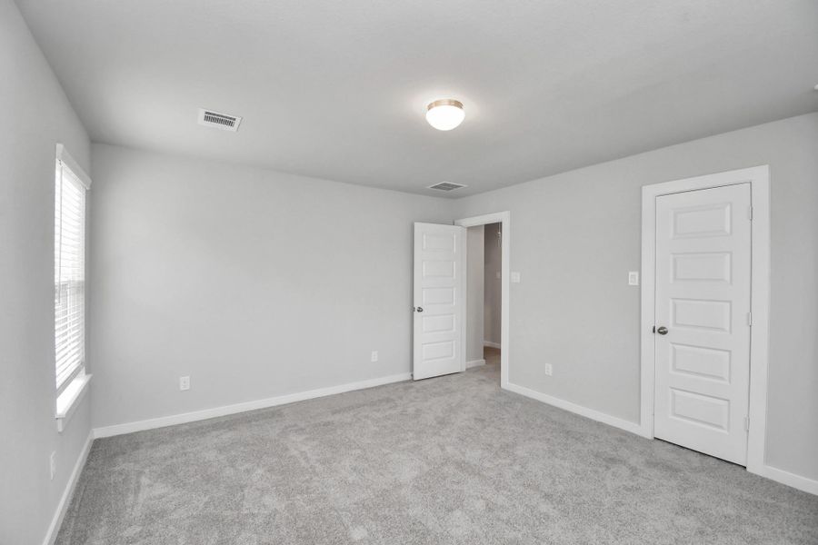 Generously sized secondary bedrooms featuring spacious closets, soft and inviting carpeting underfoot, large windows allowing plenty of natural light, and the added touch of privacy blinds for your personal retreat.
