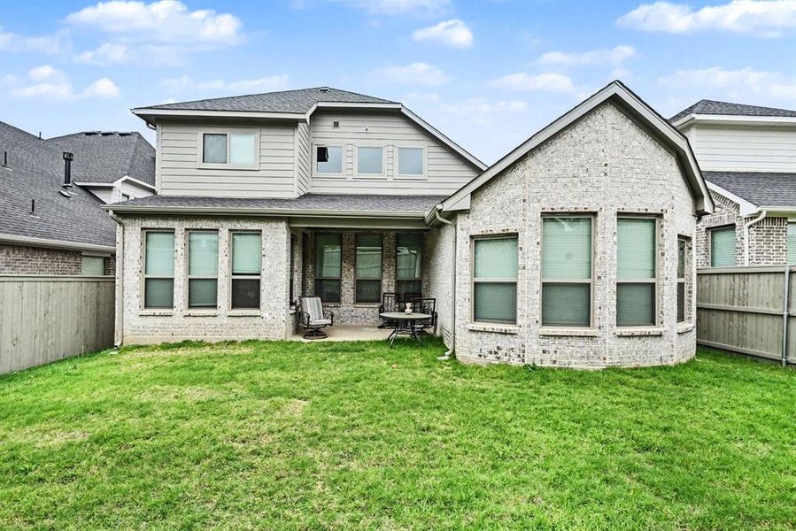 Exterior details and patio area of a home in Pecan Square, Justin (Image 20).