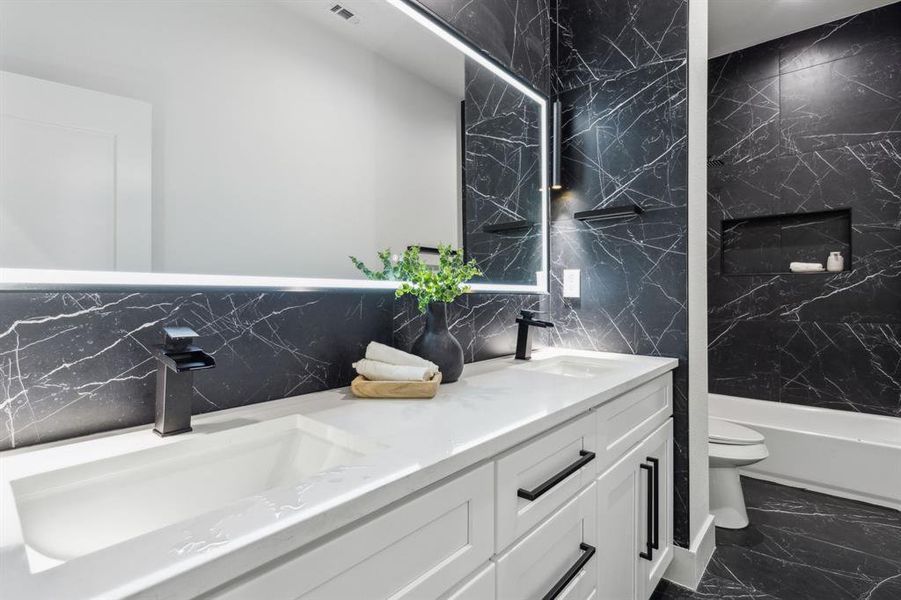 Full bathroom featuring vanity, toilet, and tub / shower combination