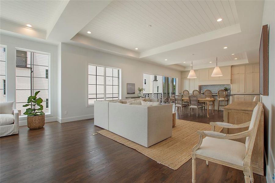 Living room with dark hardwood flooring and a tray ceiling