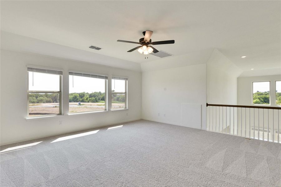 Carpeted empty room featuring a ceiling fan and recessed lighting