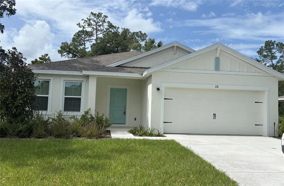 Front exterior of a new home in Aspire at Palm Coast, Palm Coast, FL, highlighting curb appeal (Image 1).