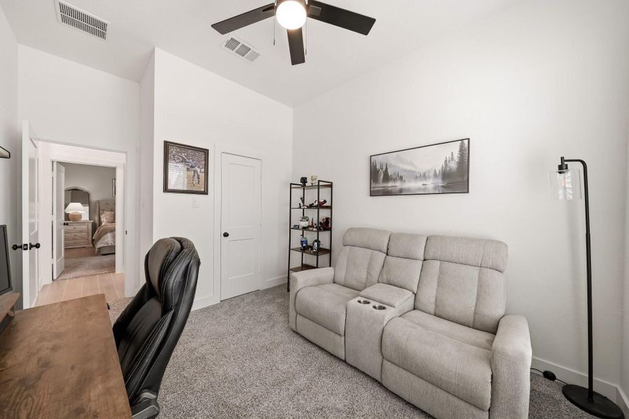 A ceiling fan with integrated lighting enhances comfort and ambiance, while the spacious walk-in closet features a shelf and hanging rod for well-organized storage.