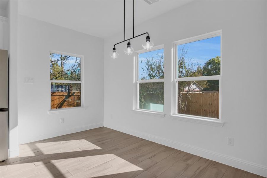 Dining area featuring wood tiled floors and baseboards