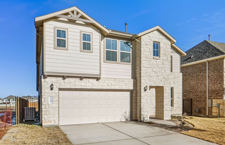 Front exterior of a new home in Saddleback at Santa Rita Ranch, Liberty Hill, TX, highlighting curb appeal (Image 23).