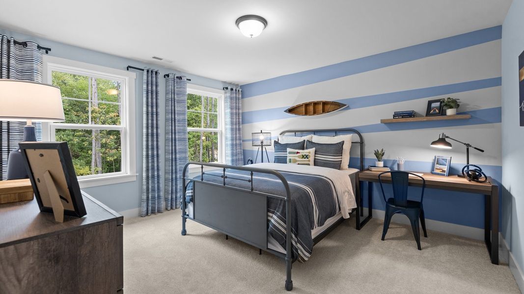 Comfortable secondary bedroom with elevated ceiling and large windows in the Jordan Design by DRB Homes in York, SC