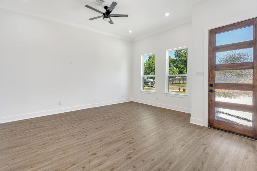 Bright living area right off the private entrance featuring large windows that bring in abundant natural light and enhance the open feel of the space.
