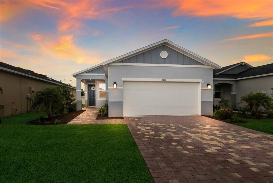 Front exterior of a new home in Heron Bay, Palmetto, FL, highlighting curb appeal (Image 2). Front exterior of a new home in Heron Bay, Palmetto, FL, highlighting curb appeal (Image 2).