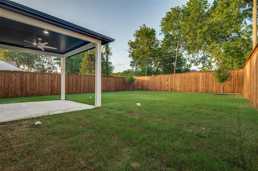 Fenced backyard featuring ceiling fan and a patio area Fenced backyard featuring ceiling fan and a patio area