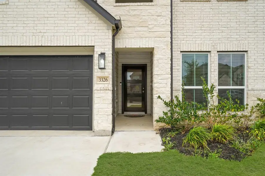 The stone and brick exterior exudes charm and elegance, creating exceptional street appeal that captivates at first glance.