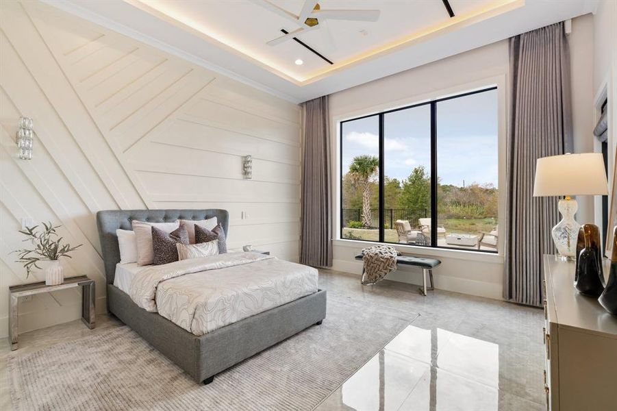 Unwind in the downstairs guest room with a peaceful view overlooking the pool and lake, complete with custom motorized drapes for added privacy and comfort.