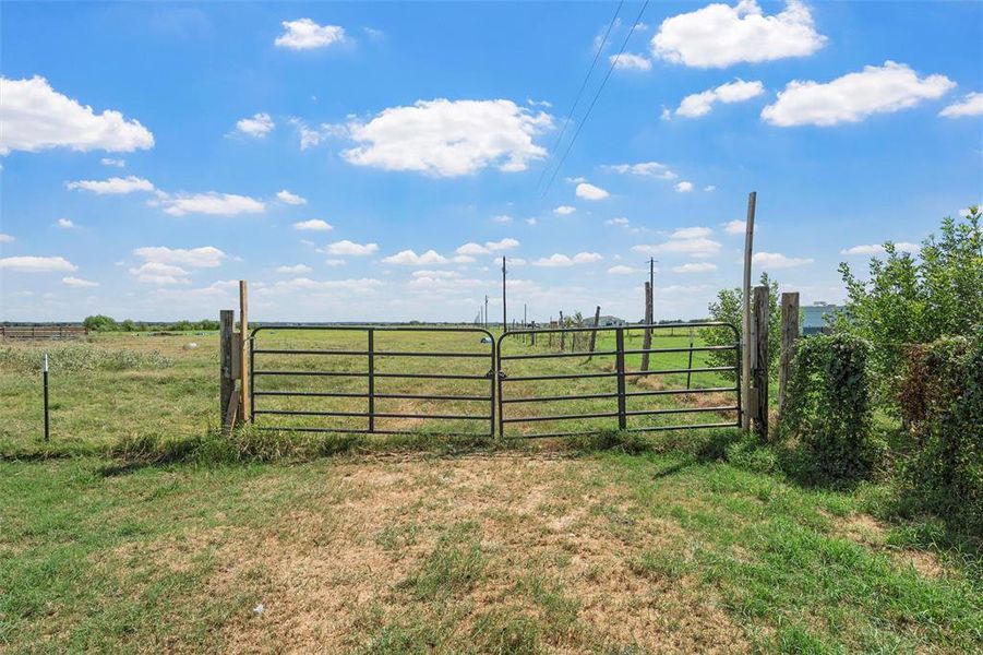 Gate featuring a view of countryside Gate featuring a view of countryside