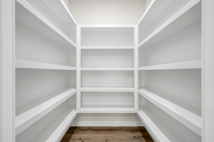 The large walk in pantry with built in shelving.